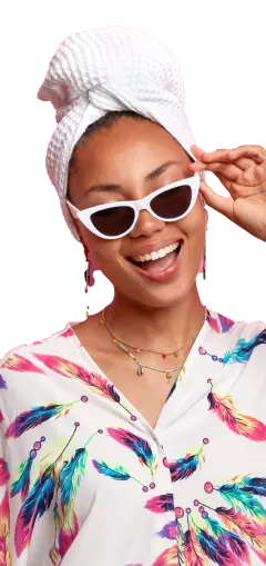 positive dark skinned woman dressed smiling with sunglass