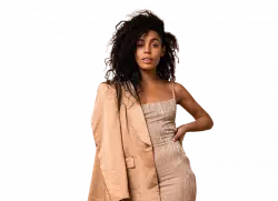 black women model with curly hair posing for photo wearing jacket