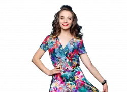 white woman with floral costume smiling and posing for photo