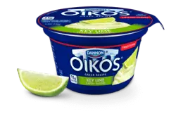 Dannon Oikos key lime Greek yogurt cup with lime slice isolated on transparent background